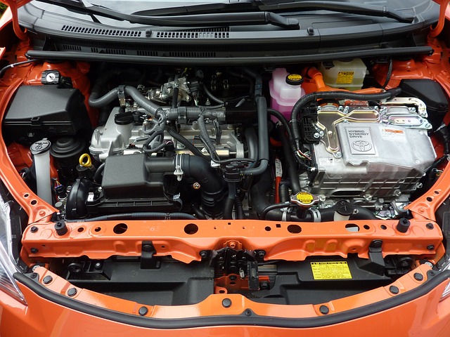Close-up of engine bay in an orange car, vehicle maintenance, car engine components, automotive repair