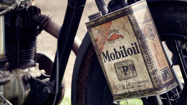 Vintage Mobiloil P can hanging on an old motorcycle, classic motor oil advertisement