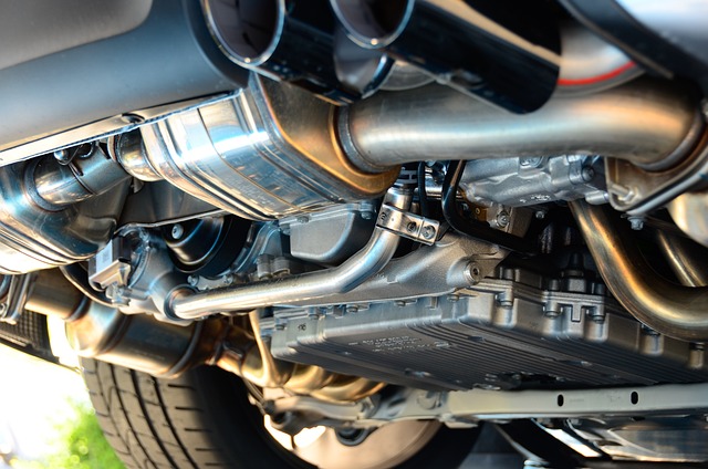 Close-up of a car's exhaust system, transmission, and undercarriage, showcasing automotive engineering